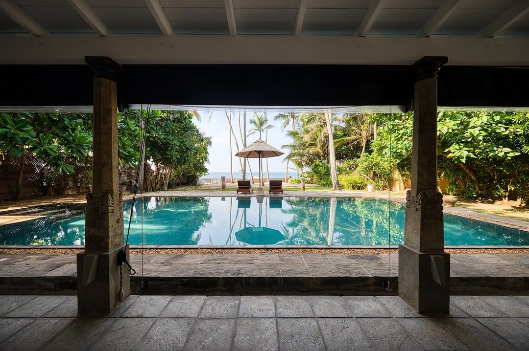 Villa Bleu Unawatuna pool with timber pergola and Indian Ocean view daytime