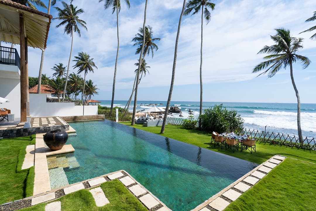 Villa Salt Talpe ground level view of pool, garden and Indian Ocean beyond