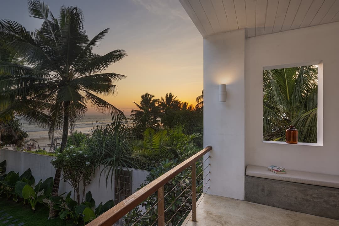 Ahangama beachfront villa upper balcony with palm tree and sunset view