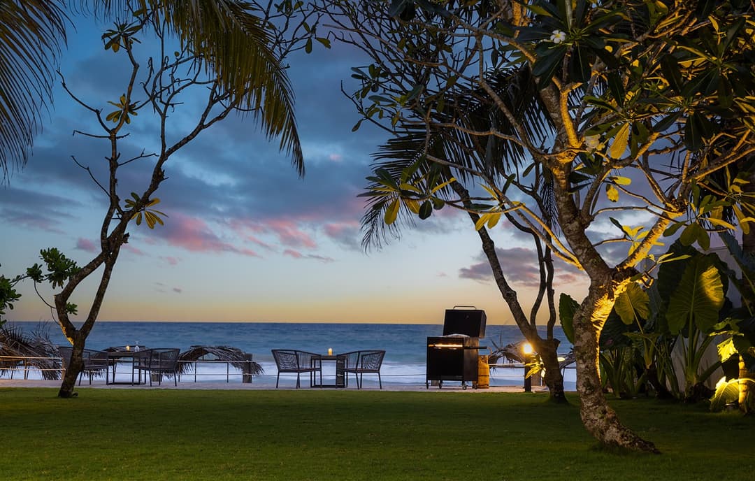 Kabalana Beach Ahangama at sunset with golden sky and tall palm trees
