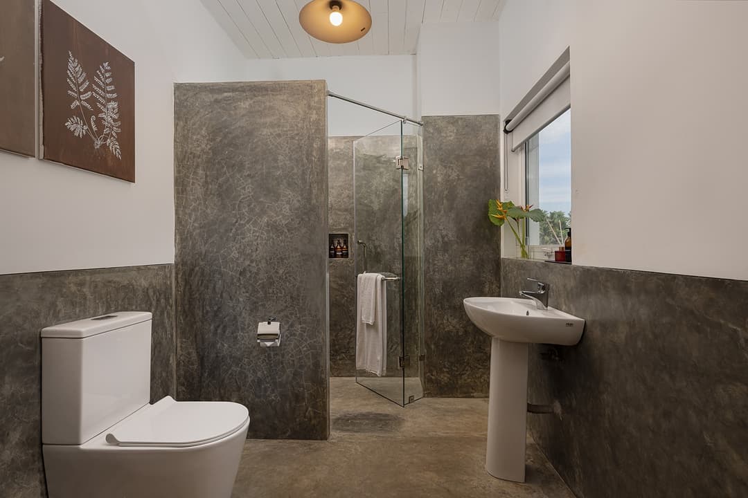 Ahangama beachfront villa bathroom with dark slate shower and contemporary toilet