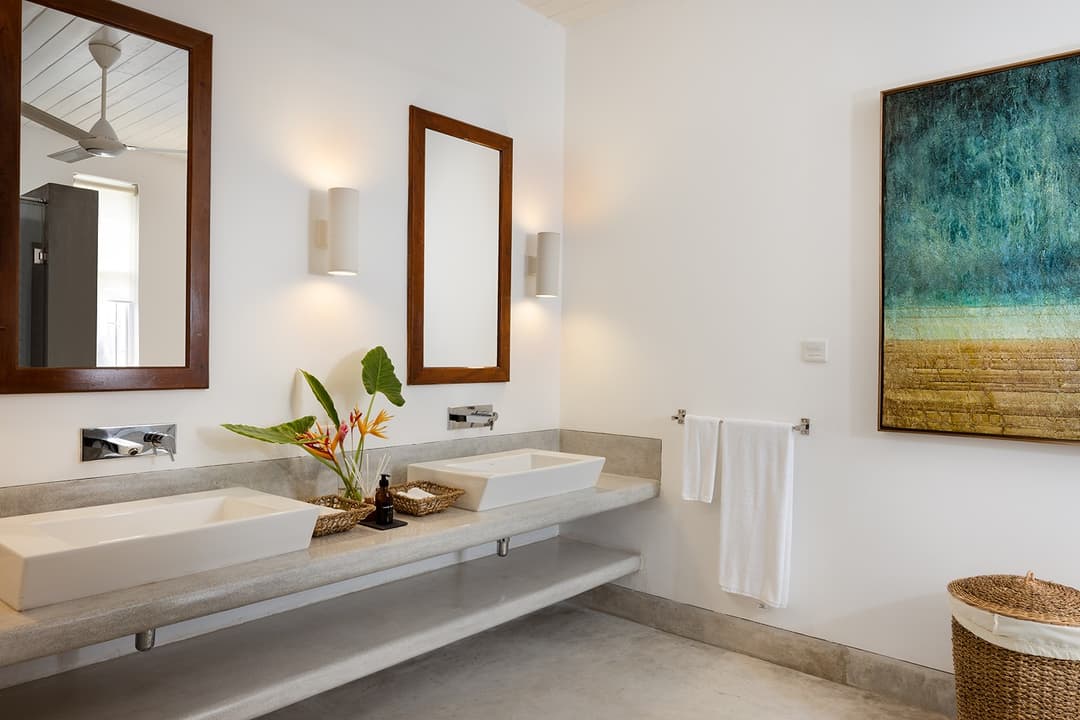 Ahangama beachfront villa ensuite bathroom with twin basins and teal ocean artwork