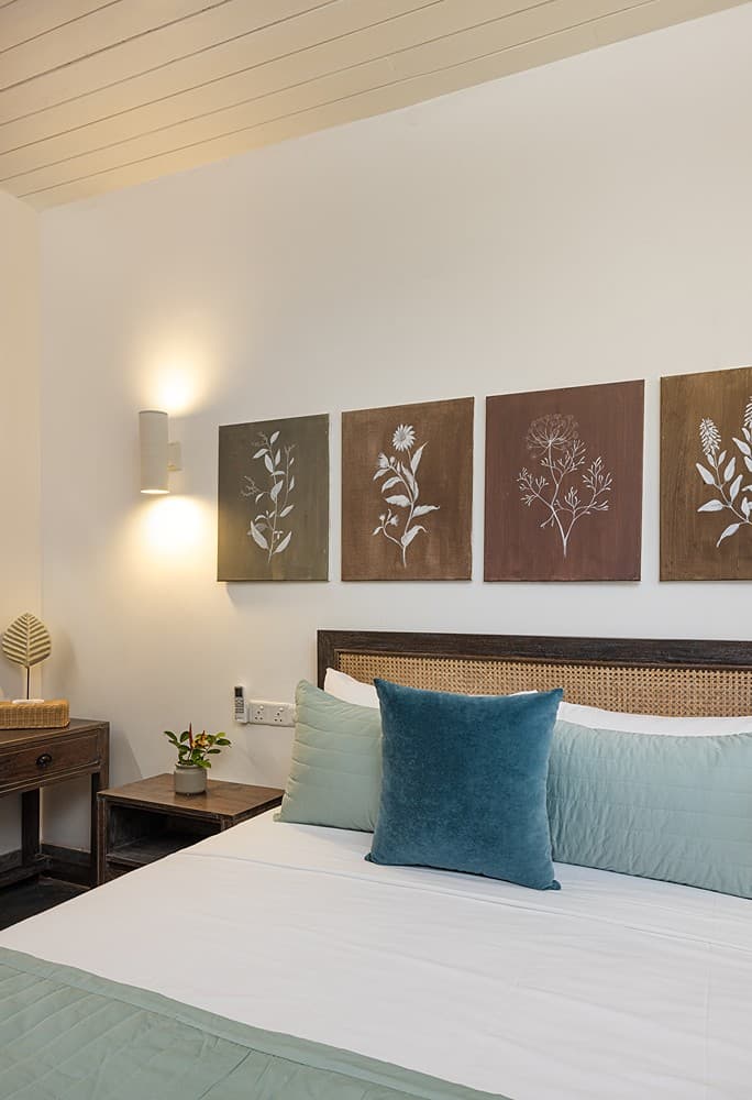Ahangama beachfront villa bedroom with blue ocean artwork and wall lamp