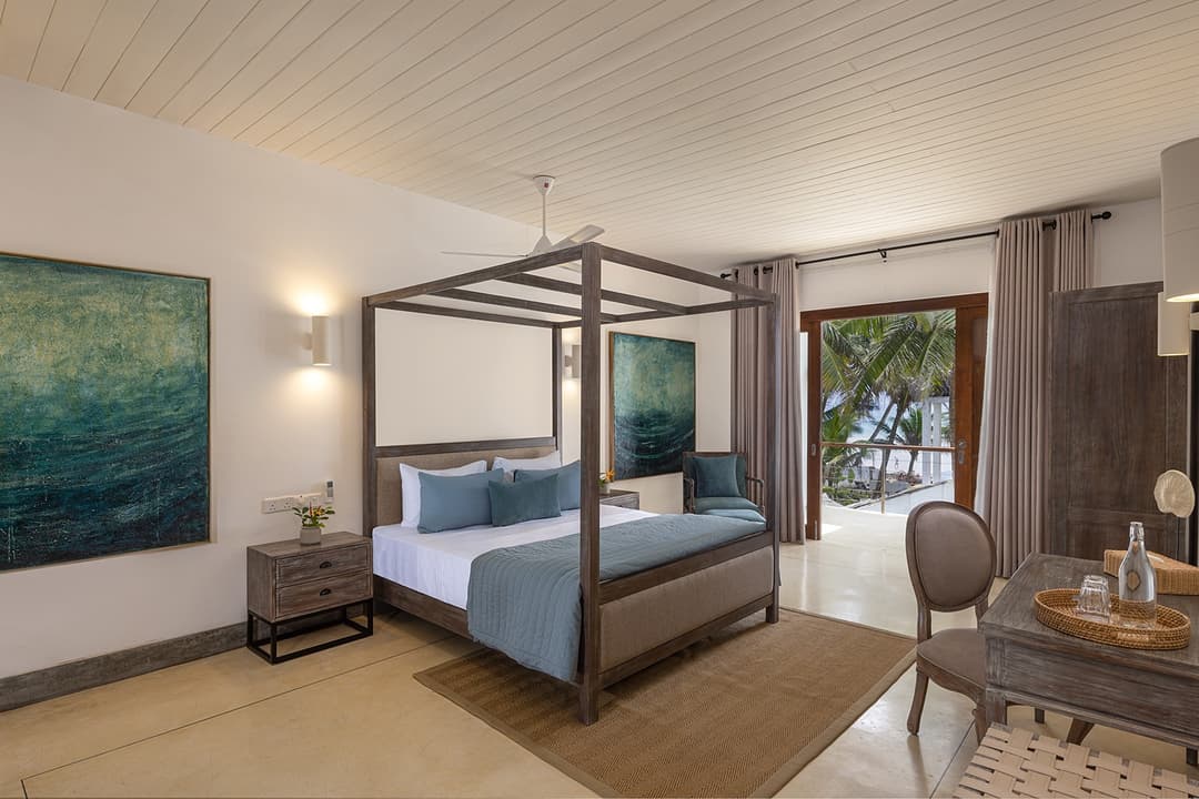 Ahangama beachfront villa bedroom with four-poster bed and teal blue palette