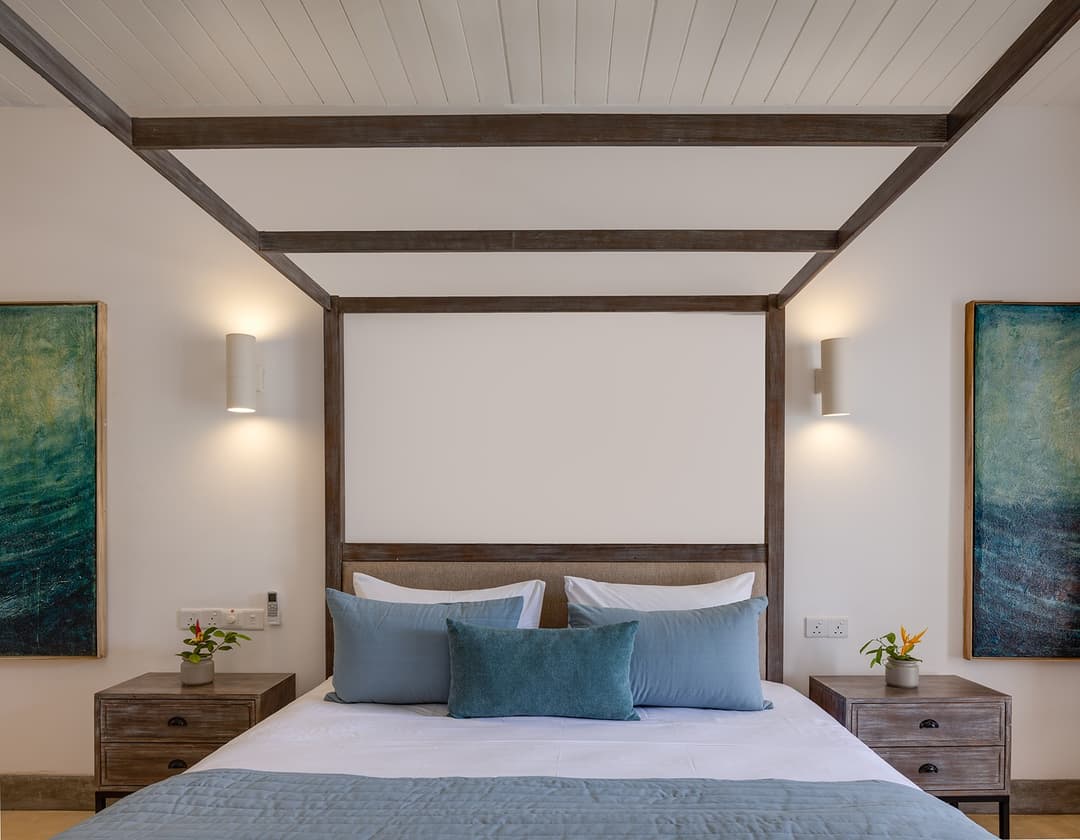 Wide angle Ahangama beachfront villa bedroom with four-poster bed and artwork