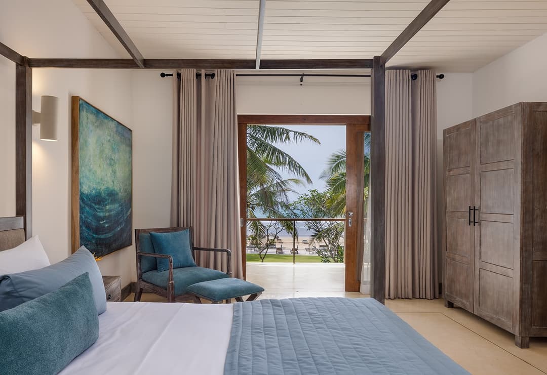 Ahangama beachfront villa bedroom sitting area with blue chair and ocean view