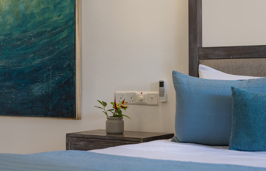 Ahangama beachfront villa bedroom side table detail with teal cushions
