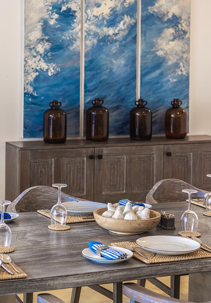 Ahangama beachfront villa dining table formally set with glasses and blue accents
