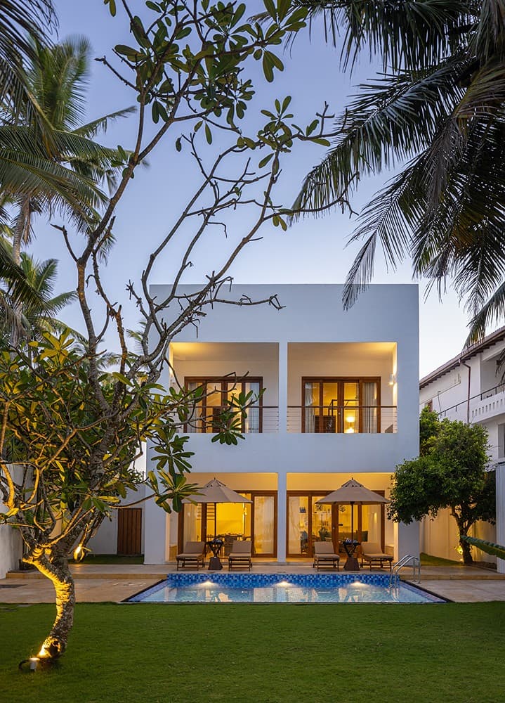 Verde Ahangama two-storey exterior with garden and frangipani trees daytime