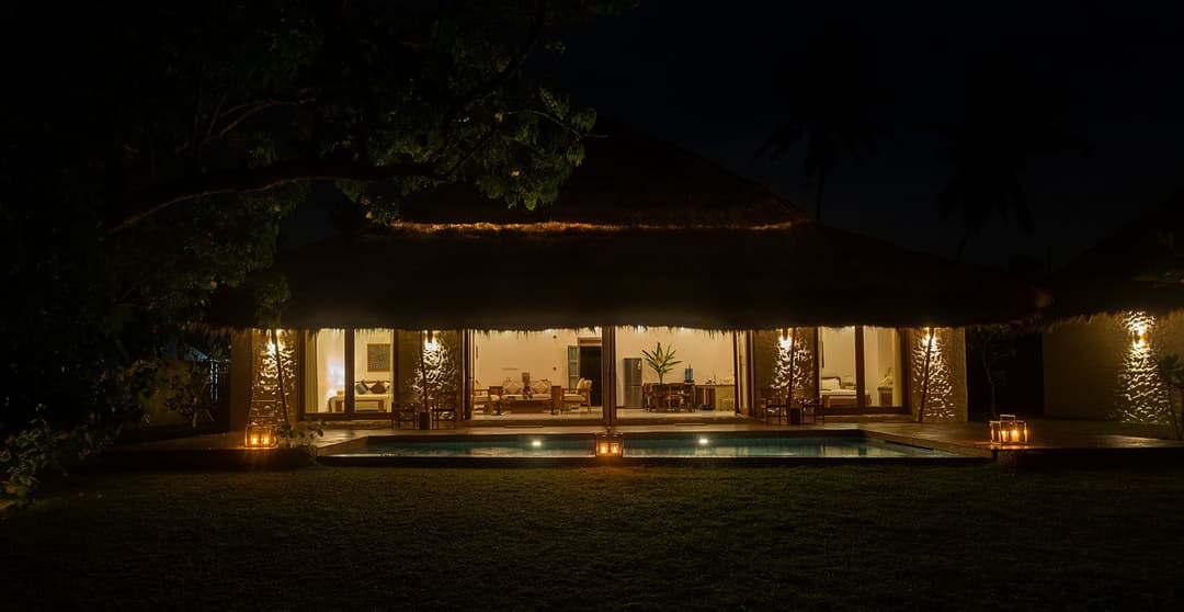 Boho House Mirissa illuminated at night with Indian Ocean beyond