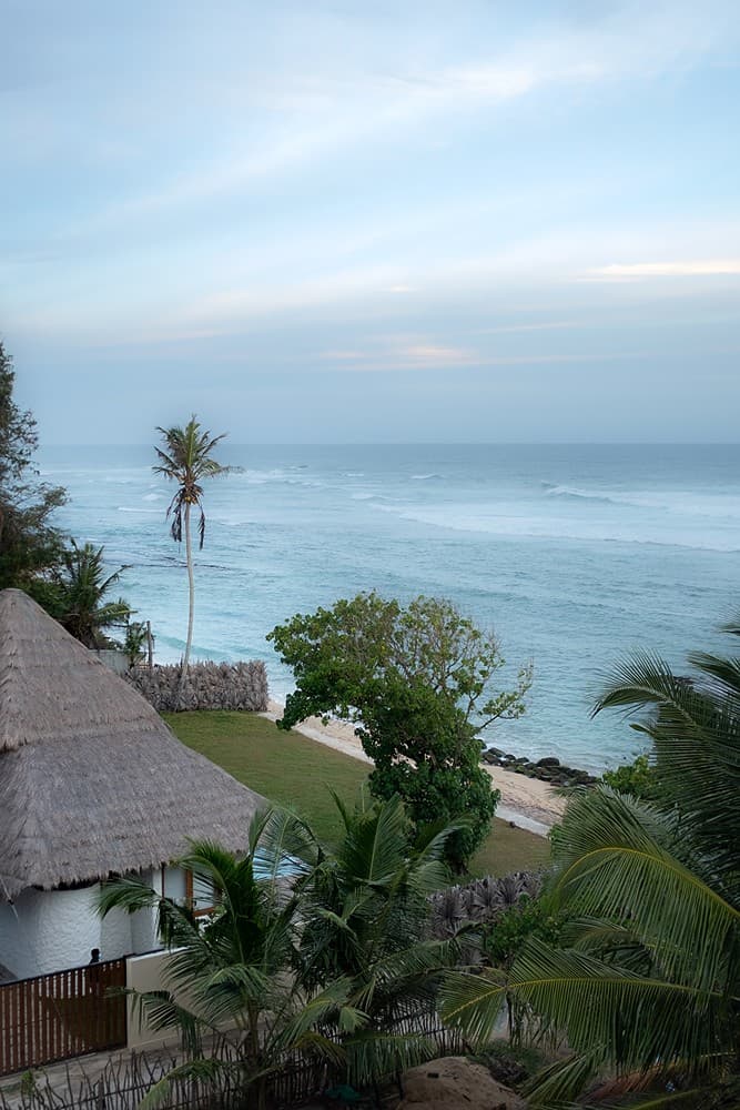 Boho House Mirissa exterior with thatched roof, pool and ocean view