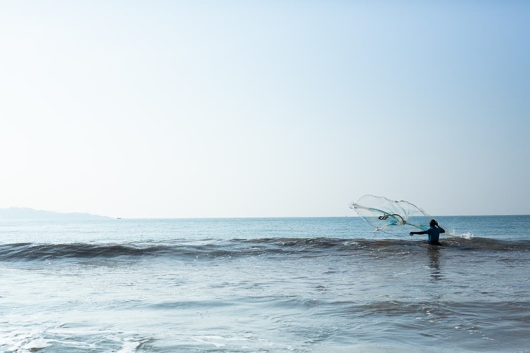 Calm Indian Ocean at Mirissa with fisherman and blue horizon Sri Lanka