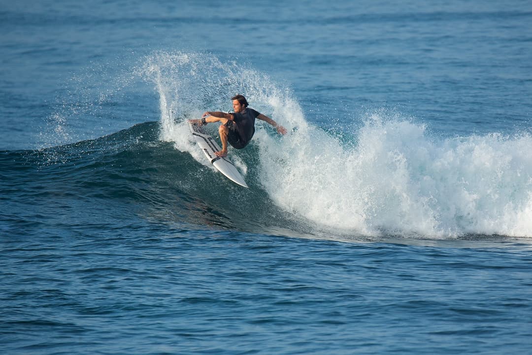 Surfer performing cutback on blue wave at Mirissa Sri Lanka