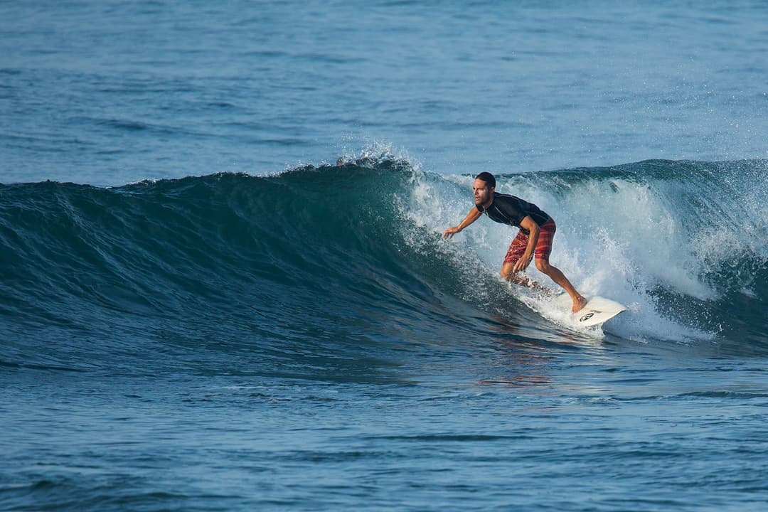 Surfer riding wave at Mirissa surf break Sri Lanka