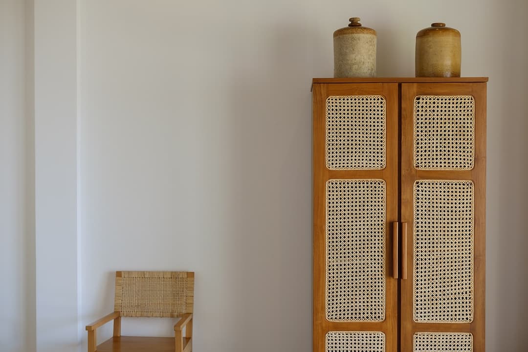 Mirissa villa bedroom detail with timber wardrobe and clay vessels