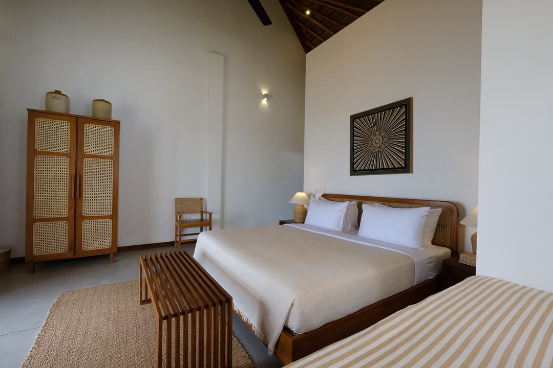 Mirissa villa bedroom with double bed and timber wardrobe natural tones