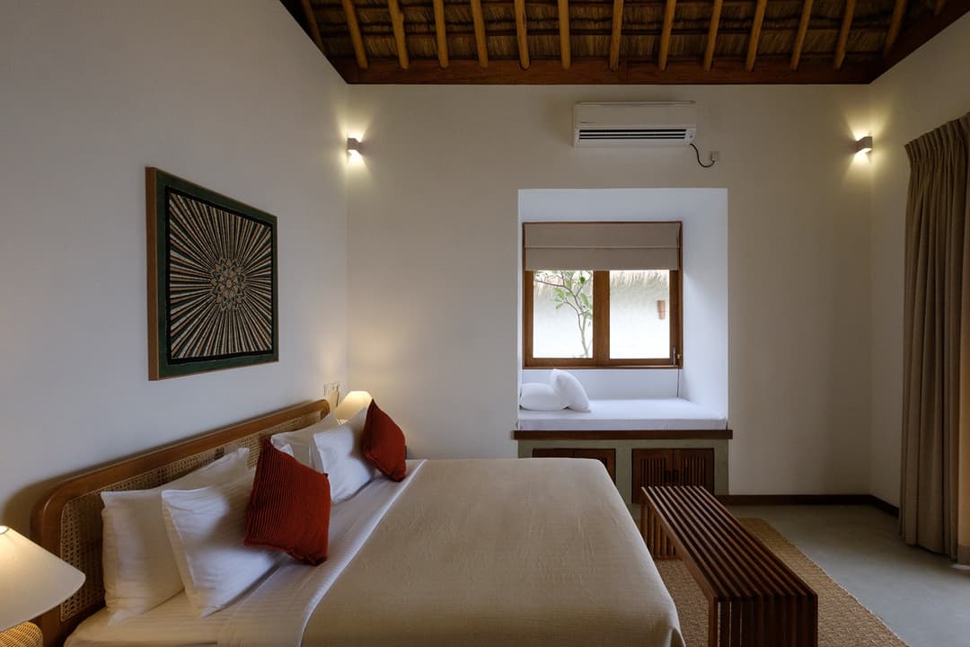 Mirissa villa bedroom with king bed, timber window frame and artwork