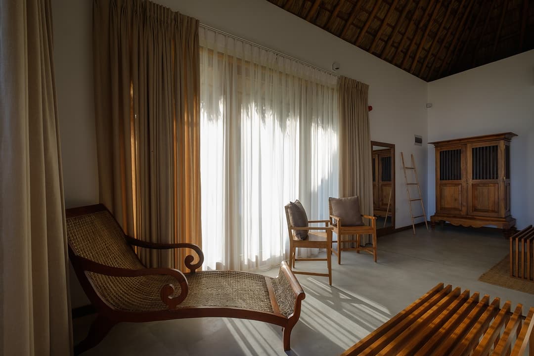 Mirissa villa master suite with sofa, ocean view and thatched ceiling