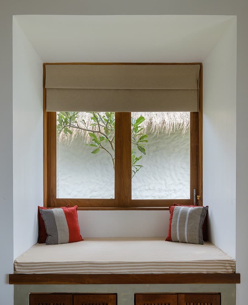 Mirissa villa bedroom sitting area with window and tropical garden view