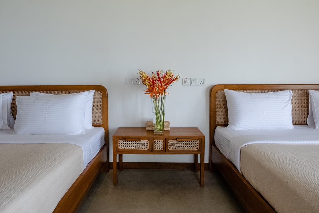 Mirissa villa bedroom with twin beds and thatched timber ceiling