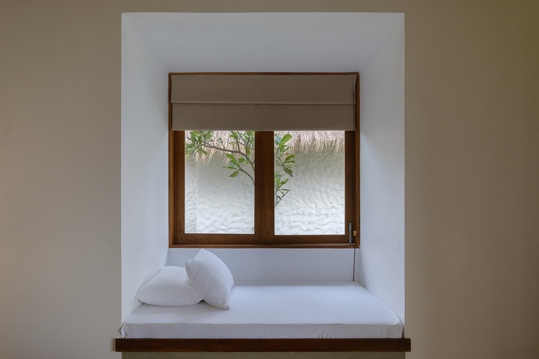 Mirissa villa bedroom window with white linen and flooding natural light