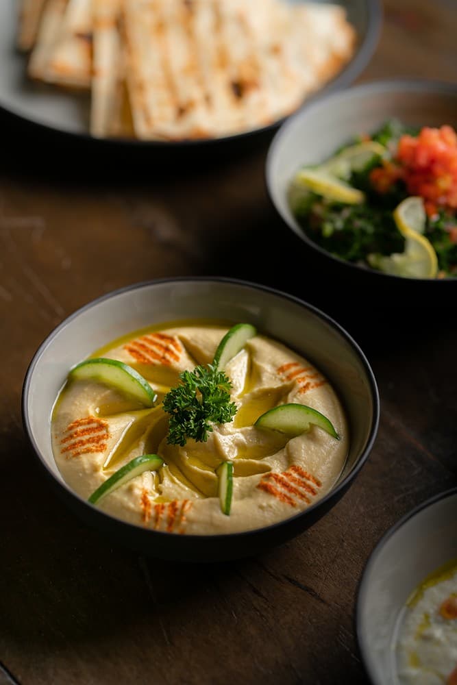Overhead villa chef mezze spread with salad and hummus bowls Mirissa