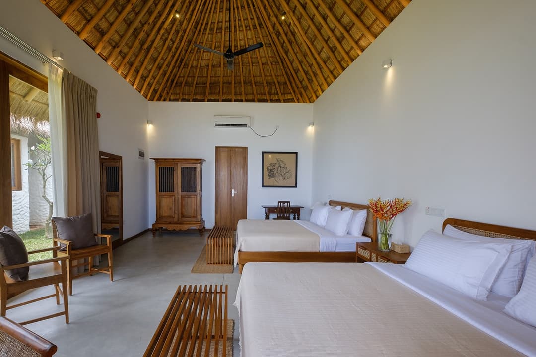 Mirissa villa family room wide angle with thatched ceiling and timber