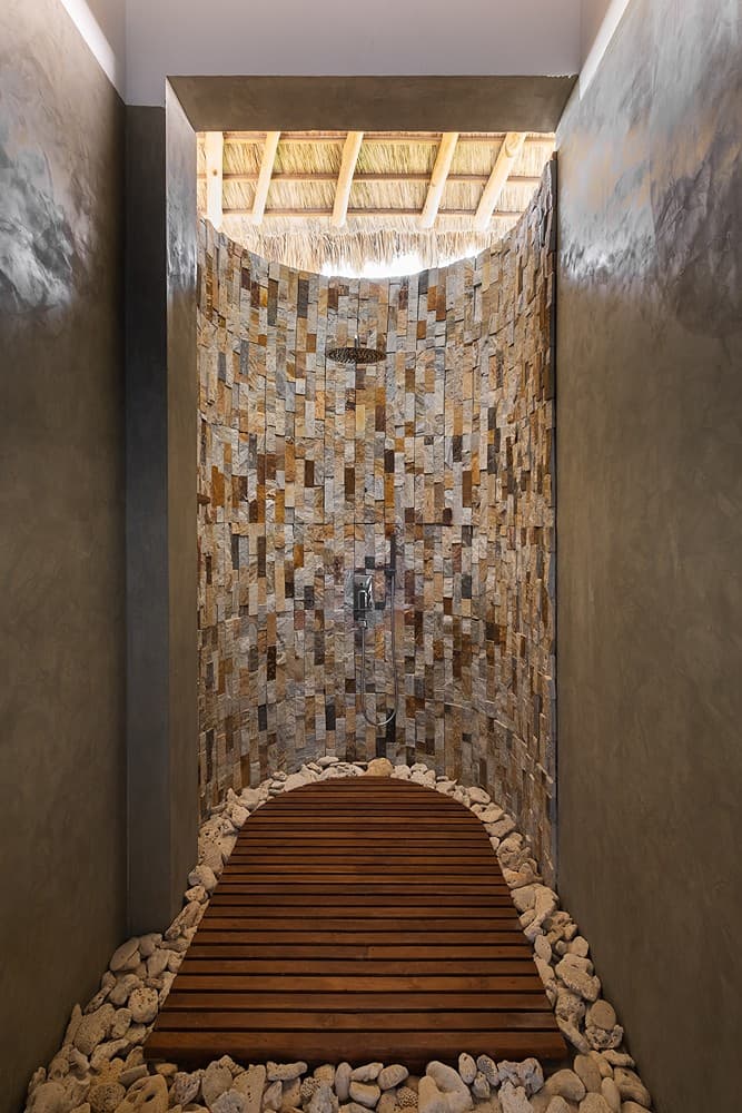 Overhead view of Mirissa villa outdoor shower with pebble stone wall