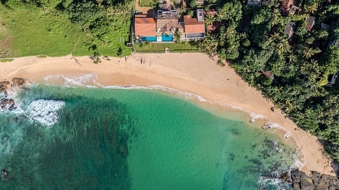 Aerial view of Sol House private bay villa gardens and beach Mirissa