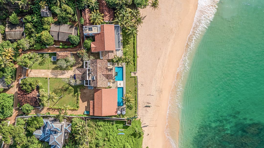 Aerial overview of Sol House villa property and private beach Mirissa