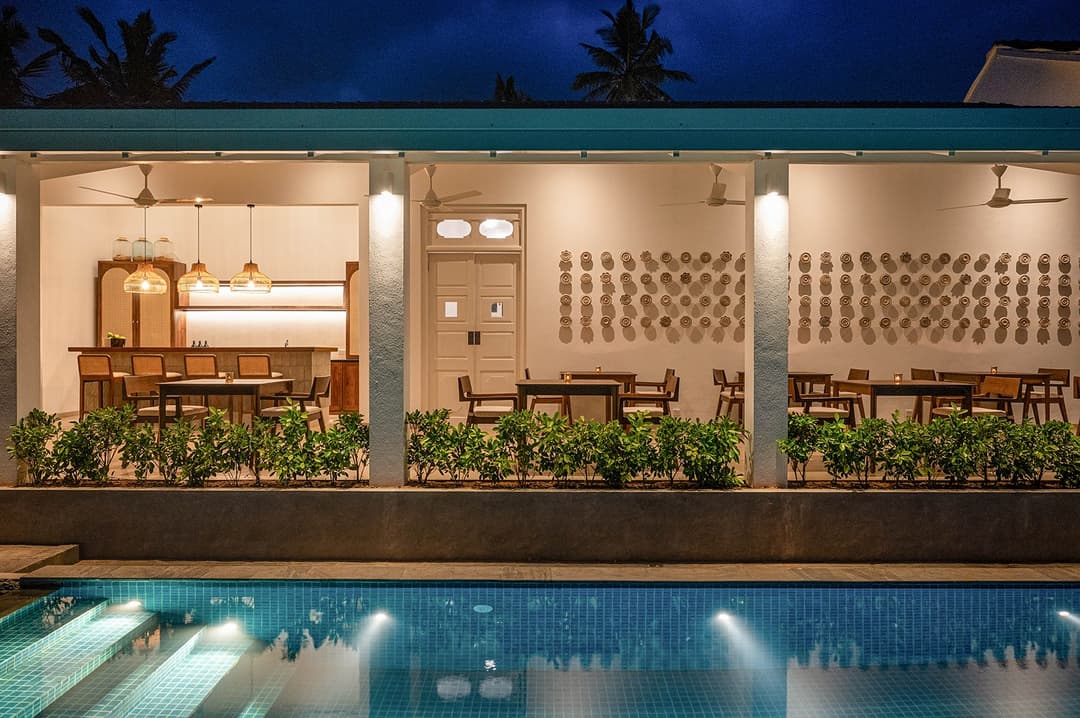 Mirissa luxury villa bar with rattan pendants, cane stools and backlit display