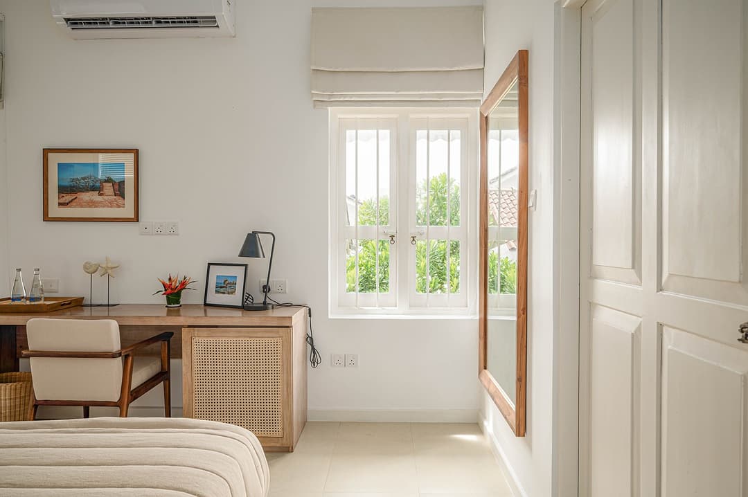 Mirissa luxury villa bedroom with garden view, timber desk and artworks