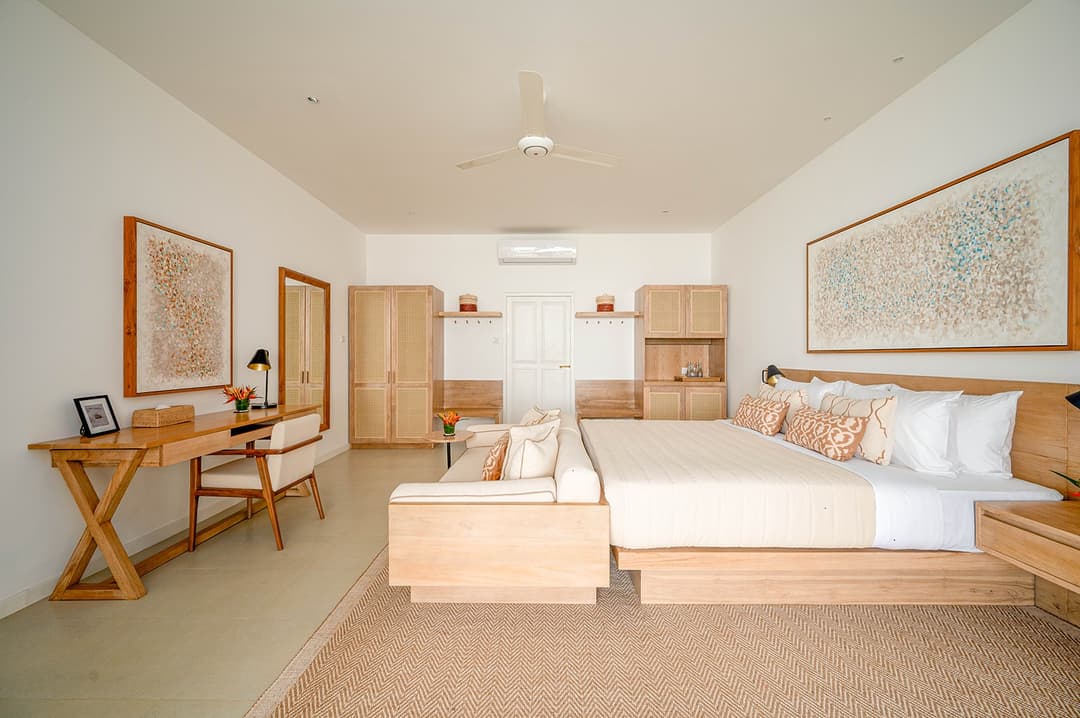 Mirissa luxury villa bedroom with king bed, cream linen and wall artwork