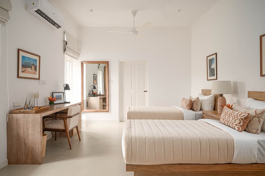 Mirissa luxury villa bedroom with king rattan headboard and cream linen
