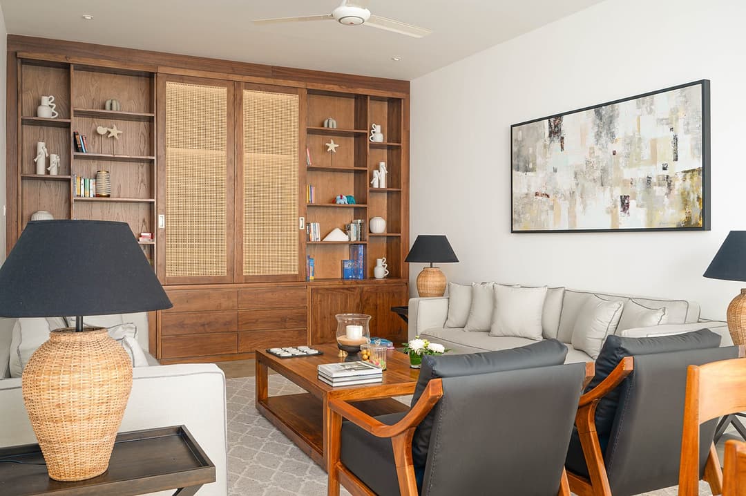 Mirissa luxury villa bedroom with timber bookcase, dark lamp and sofa