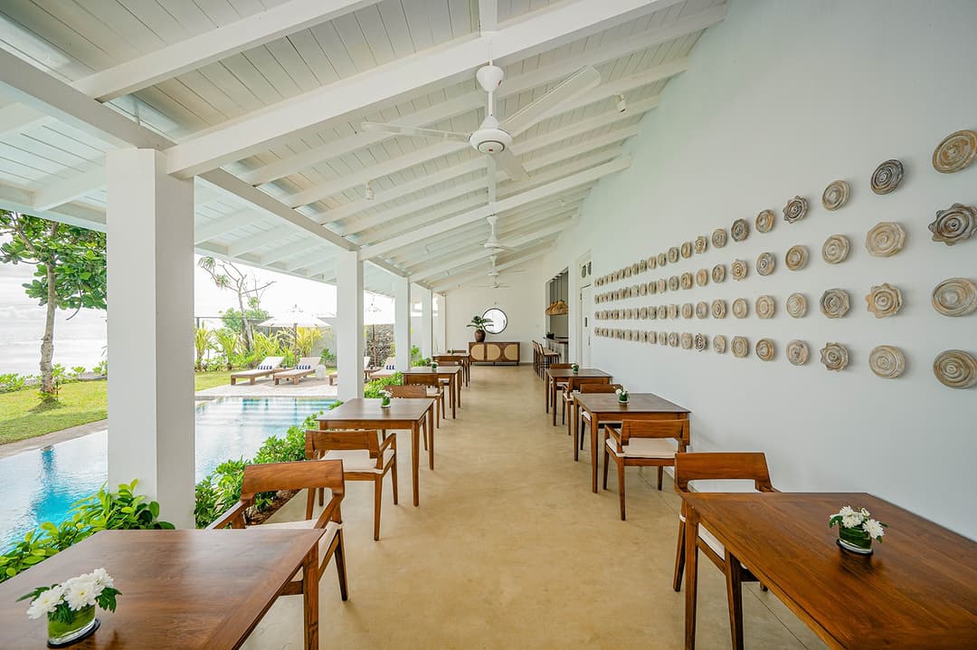 Mirissa luxury villa covered corridor with wall art and ocean garden view