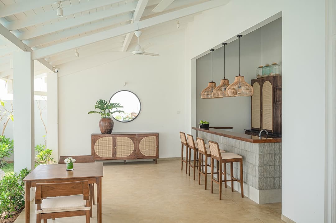 Mirissa luxury villa kitchen and dining area with rattan cabinet and round mirror