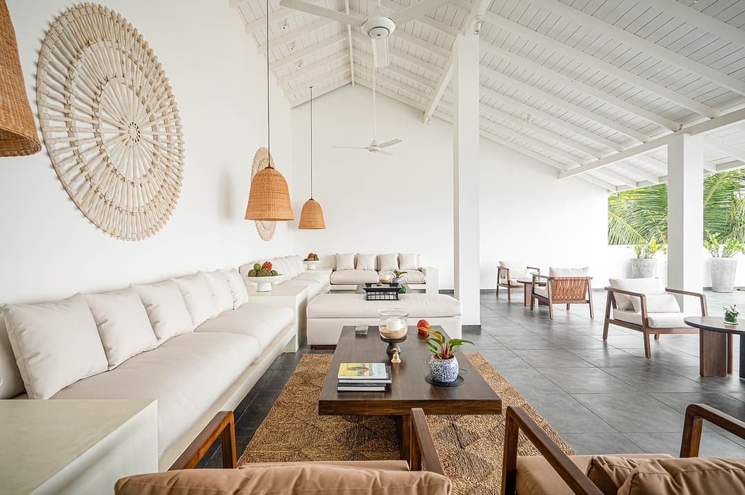 Mirissa luxury villa living room with rattan wall art and dark dining table