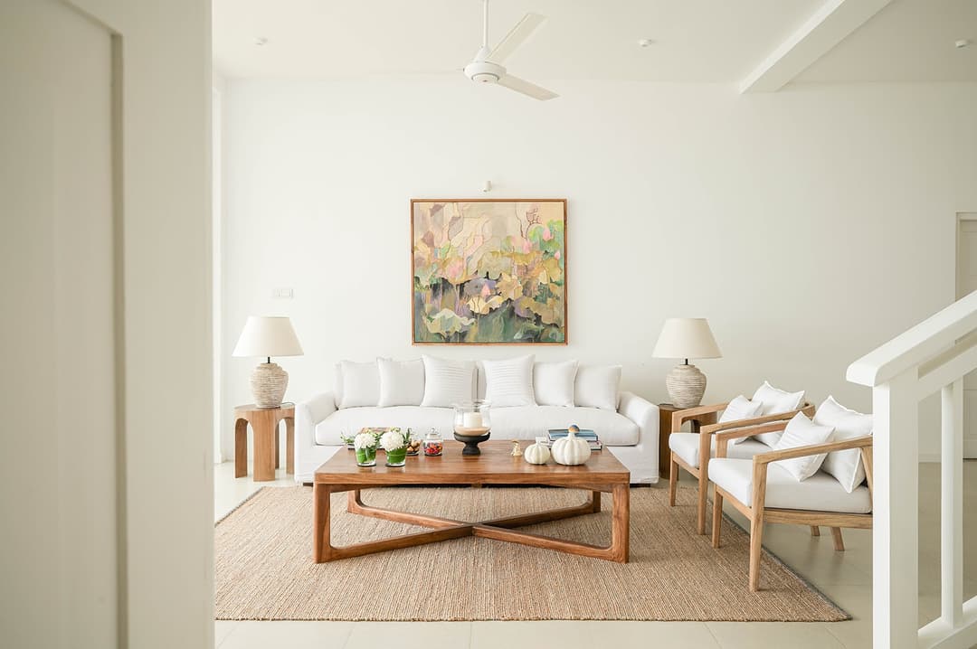 Mirissa luxury villa living room with timber chairs and white sofas wide
