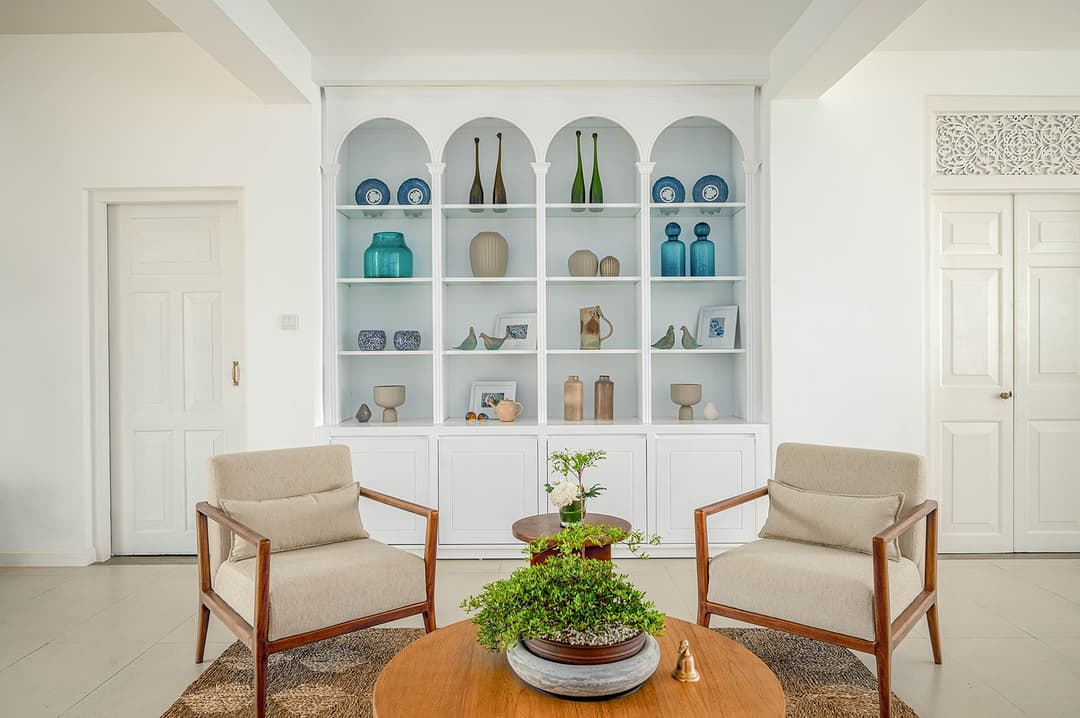 Mirissa luxury villa lounge with arched display shelving and white chairs