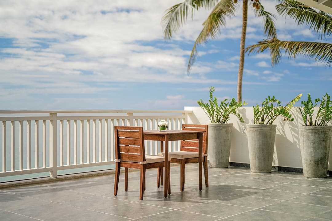 Mirissa luxury villa ocean terrace with dining table and palm trees