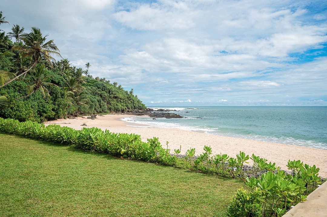 Mirissa luxury villa private bay with expansive lawn and coastal garden view