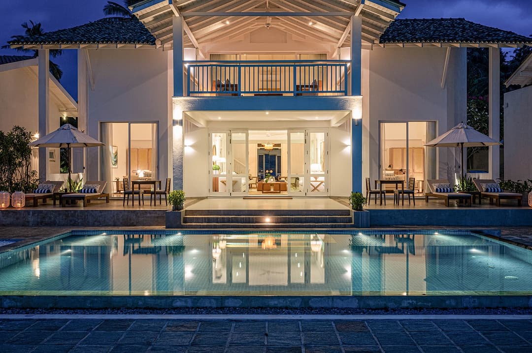 Sol House Mirissa facade at night with pool and deep blue ambient light