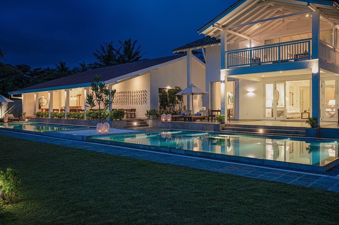 Sol House Mirissa exterior illuminated at night with pool and tropical garden