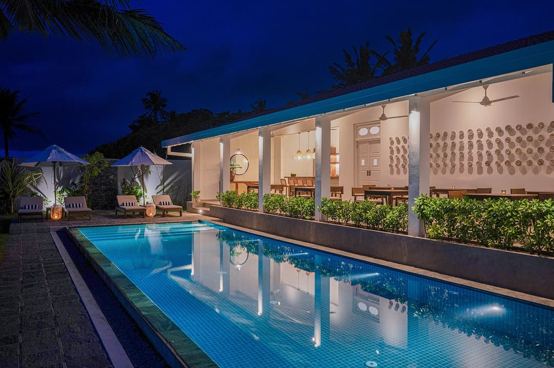 Sol House Mirissa pool at night long view fully illuminated