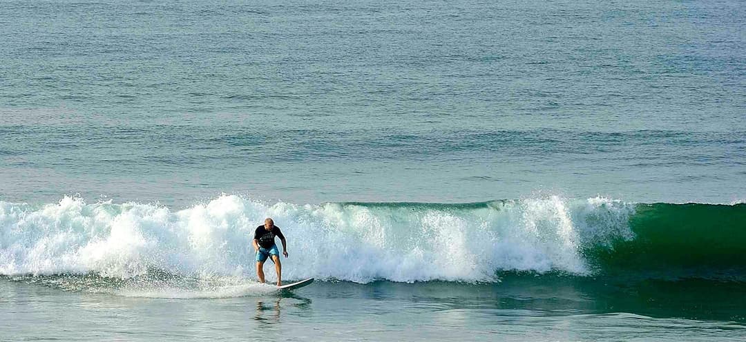 Surfers riding waves at Matara beach Sri Lanka