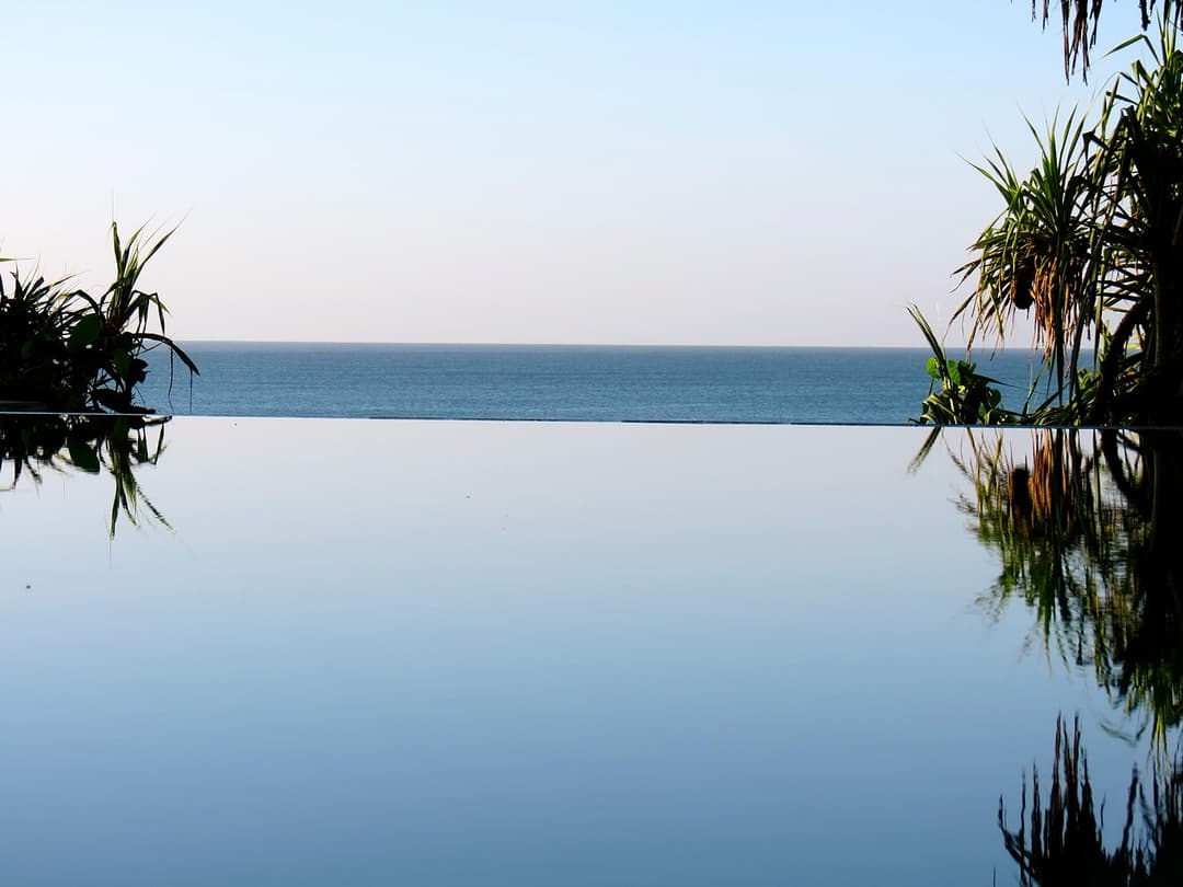 Matara villa infinity pool with calm ocean horizon reflection Sri Lanka