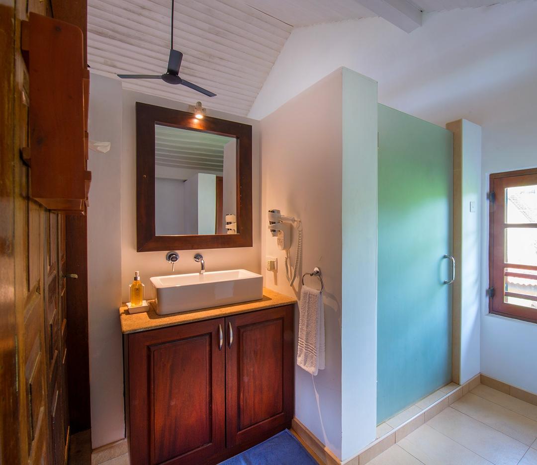Matara villa loft bathroom with timber vanity basin and mirror