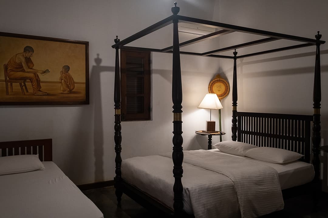 Matara villa loft bedroom with four-poster canopy bed and antique lamp
