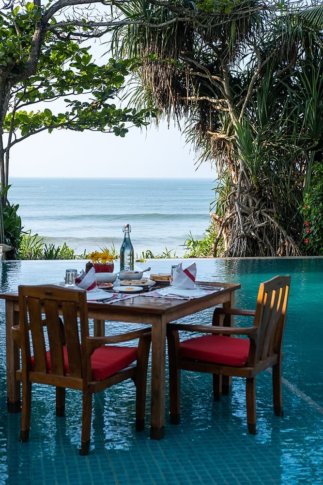 Matara villa outdoor dining table set with pool view and Indian Ocean